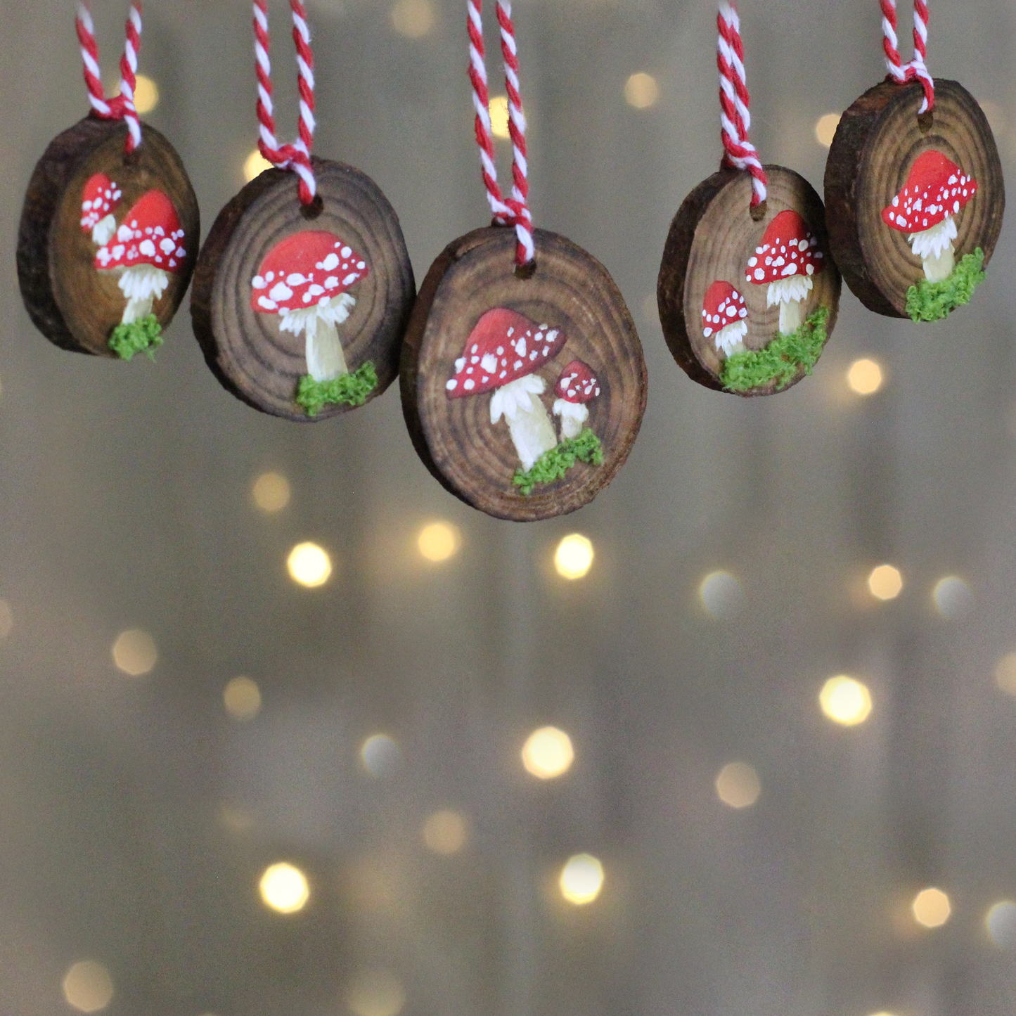 wooden discs with mushrooms painted on and embellished with moss