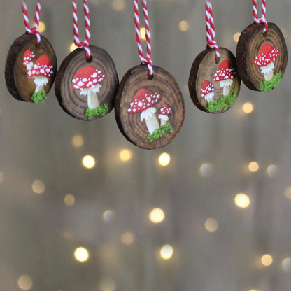 wooden discs with mushrooms painted on and embellished with moss