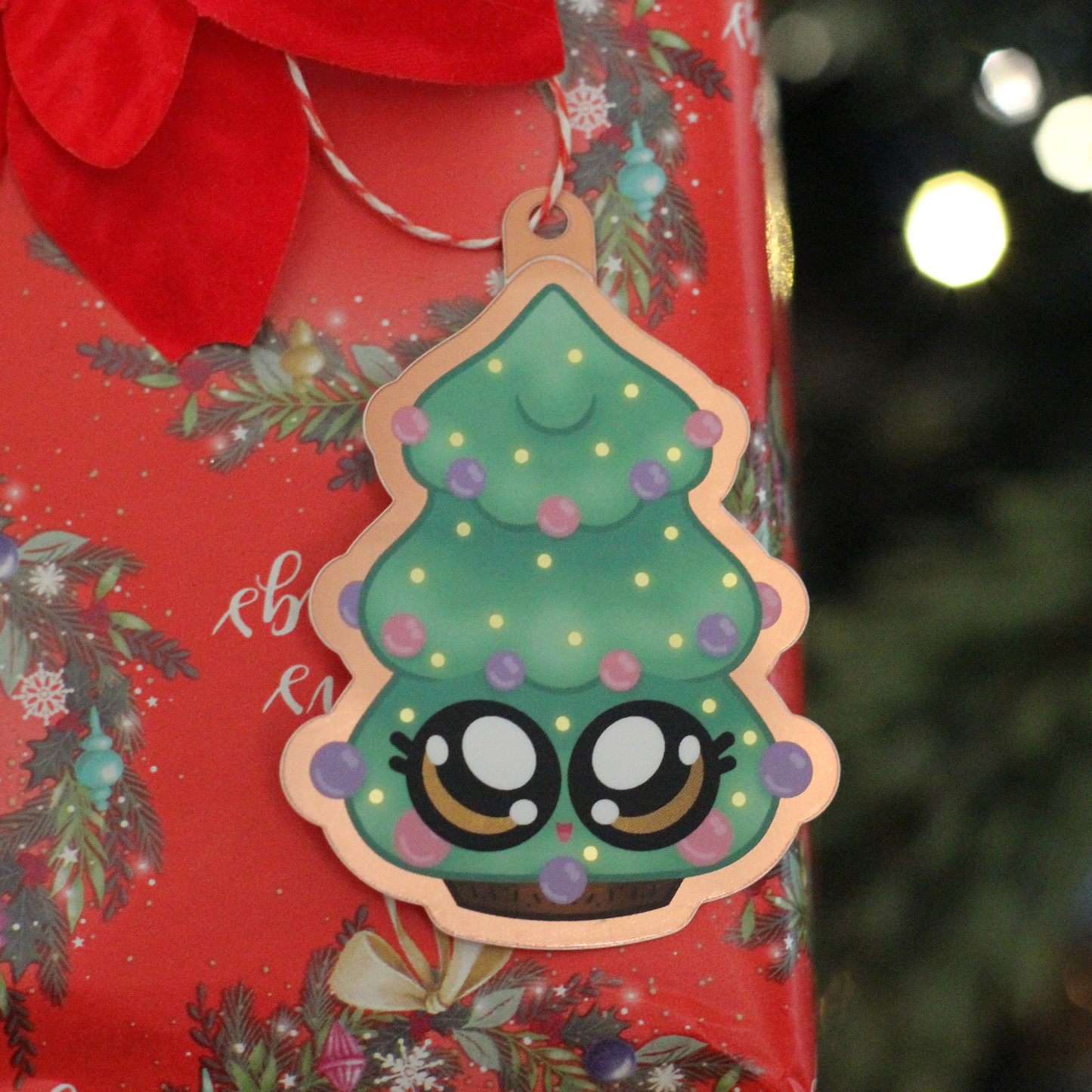 Cute christmas tree sticker gift tag hanging on wrapped present